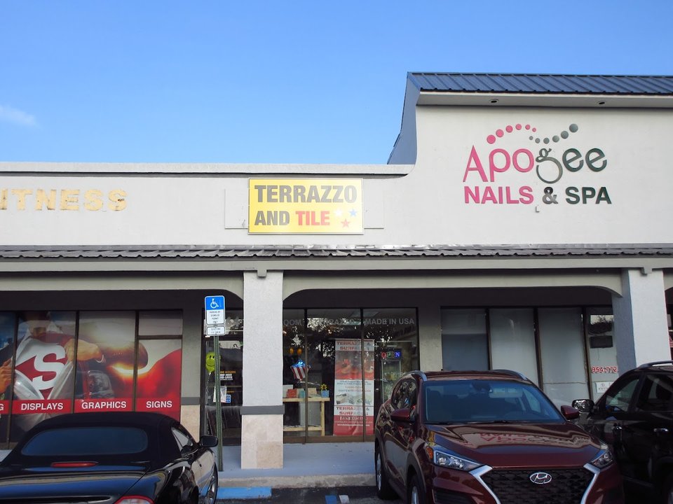Bright nail salon with colorful polish shelves.