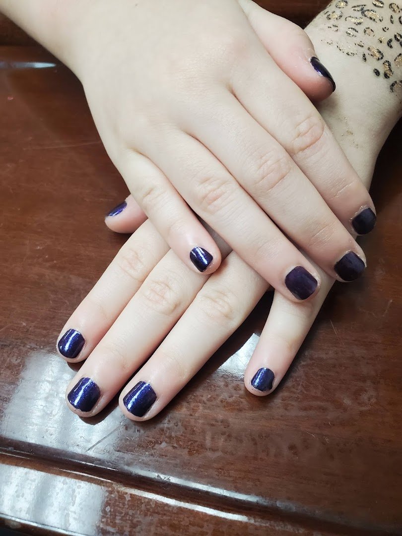 Bright nail salon with colorful polish shelves.